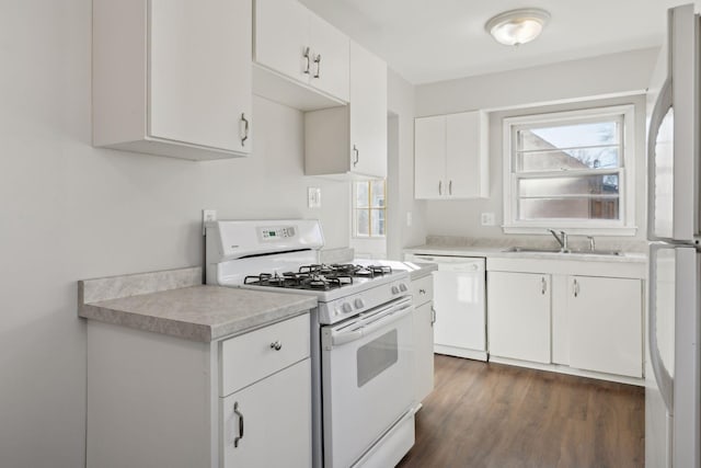 kitchen with white cabinetry, sink, white appliances, and plenty of natural light