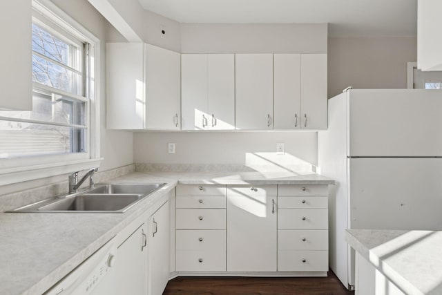 kitchen featuring white cabinetry, sink, dark wood-type flooring, and white appliances