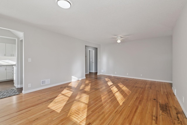 spare room with ceiling fan and light hardwood / wood-style flooring