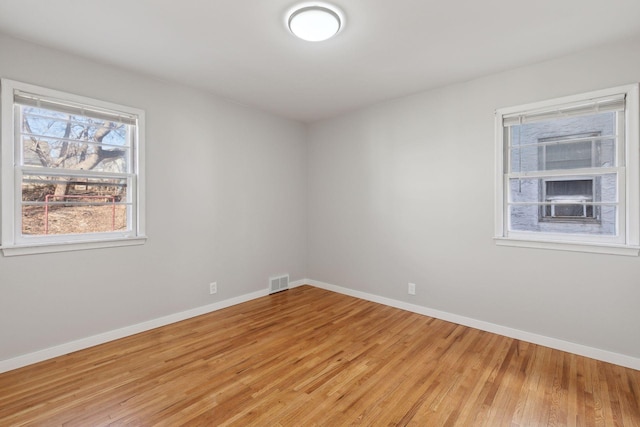 spare room with hardwood / wood-style flooring