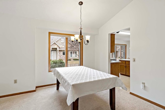 game room featuring baseboards, a notable chandelier, and a healthy amount of sunlight
