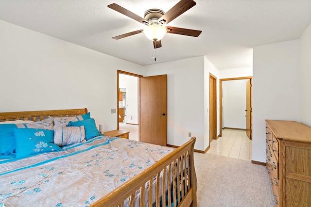 bedroom featuring baseboards, ceiling fan, and light colored carpet