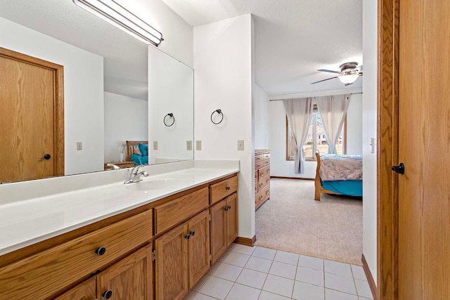 bathroom with vanity, a ceiling fan, connected bathroom, and tile patterned flooring
