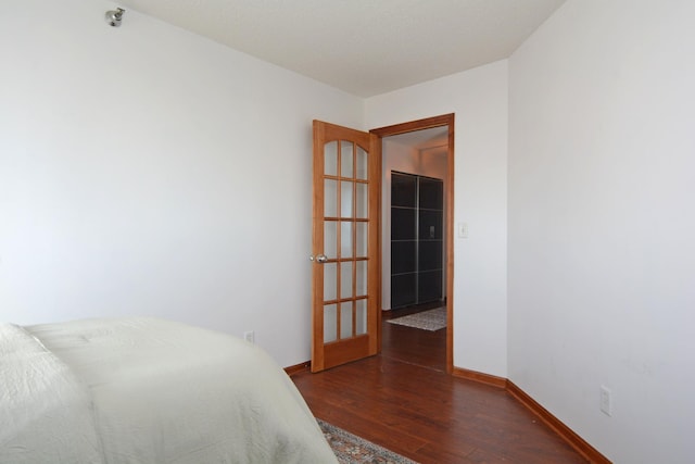 bedroom with dark hardwood / wood-style floors