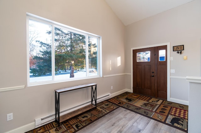 entryway featuring vaulted ceiling, wood-type flooring, and baseboard heating