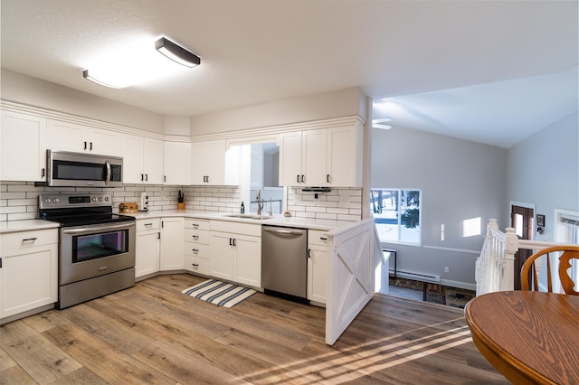 kitchen featuring white cabinetry, sink, light hardwood / wood-style flooring, and stainless steel appliances