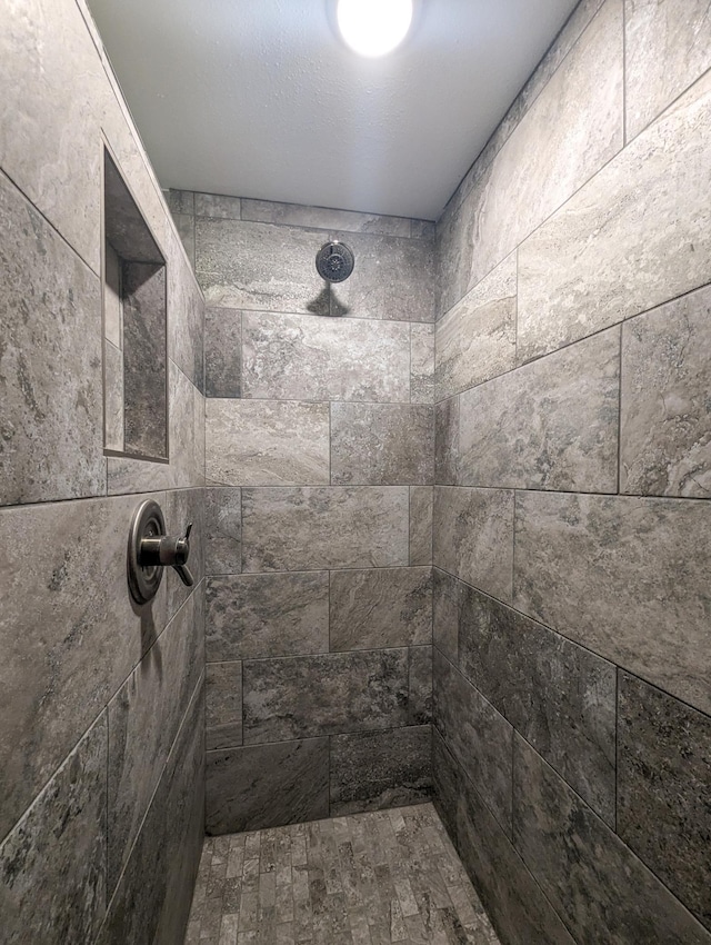 bathroom with a tile shower