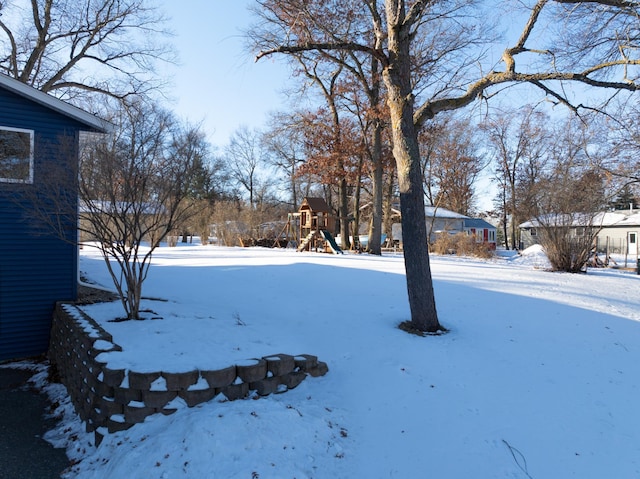 snowy yard with a playground