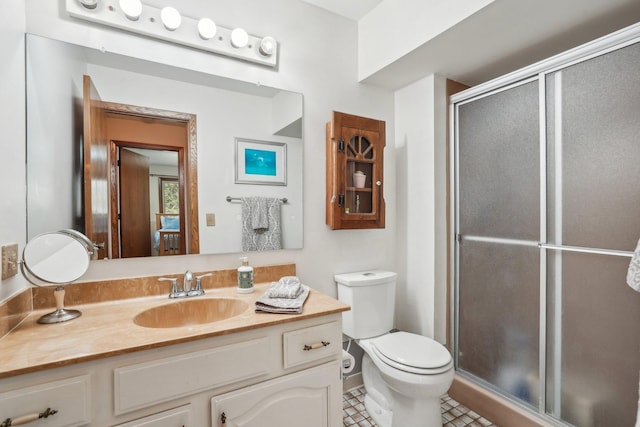 full bath featuring tile patterned flooring, toilet, vanity, and a stall shower