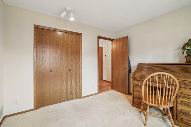 office area with light carpet and baseboards