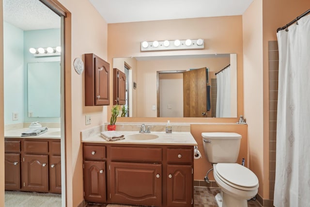 bathroom with toilet and vanity