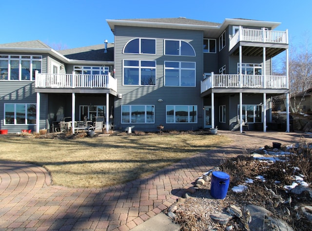 rear view of house featuring a yard