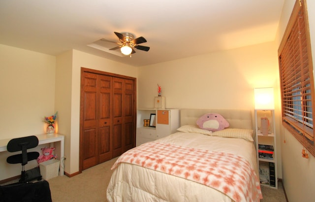 bedroom featuring ceiling fan, light carpet, and a closet