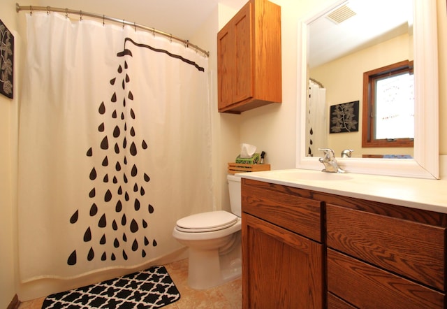 bathroom featuring a shower with curtain, vanity, toilet, and tile patterned flooring