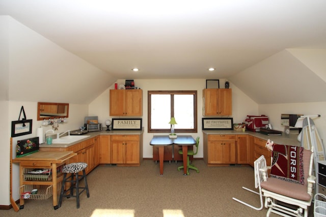 kitchen with lofted ceiling, sink, and light colored carpet