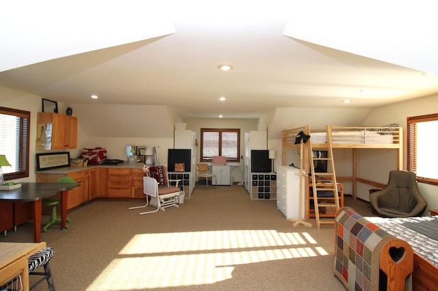 interior space with recessed lighting, light carpet, open floor plan, and light brown cabinetry