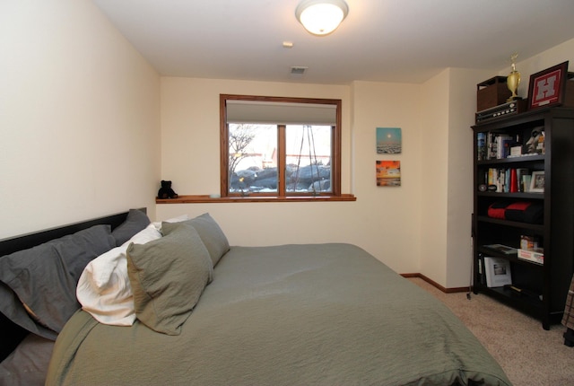 bedroom featuring light carpet, visible vents, and baseboards