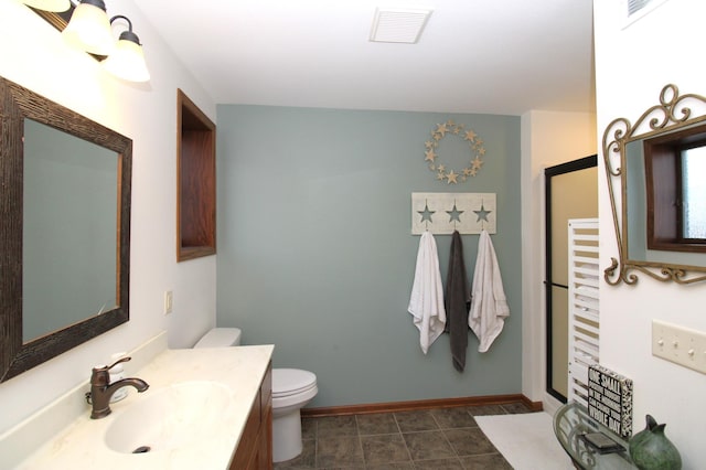 bathroom featuring vanity, baseboards, visible vents, tile patterned flooring, and toilet