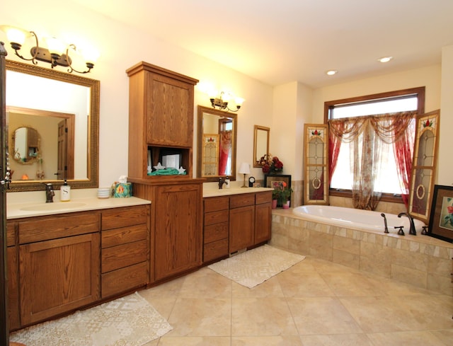 bathroom with tile patterned flooring, a bath, vanity, and recessed lighting