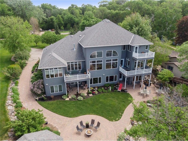 19699 623rd Ave, Litchfield, MN 55355 - back of house with roof with shingles, a patio area, a yard, and a deck