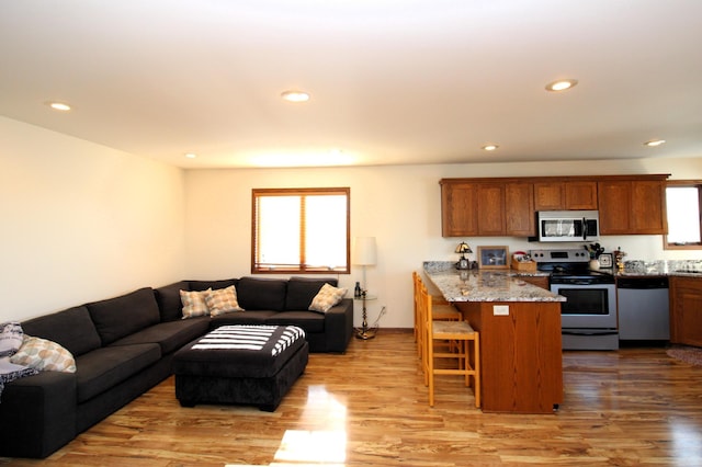 19699 623rd Ave, Litchfield, MN 55355 - kitchen featuring stainless steel appliances, a peninsula, a breakfast bar, open floor plan, and recessed lighting