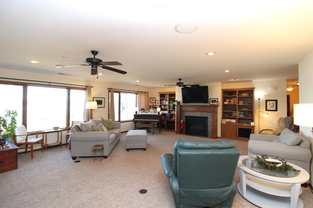 19699 623rd Ave, Litchfield, MN 55355 - carpeted living room featuring a ceiling fan, a tiled fireplace, and recessed lighting