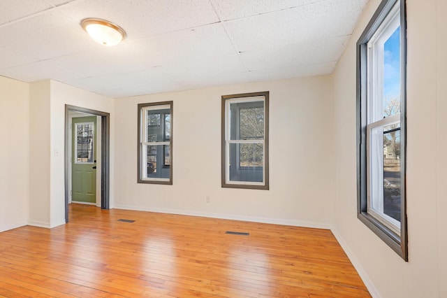 spare room featuring light wood-type flooring