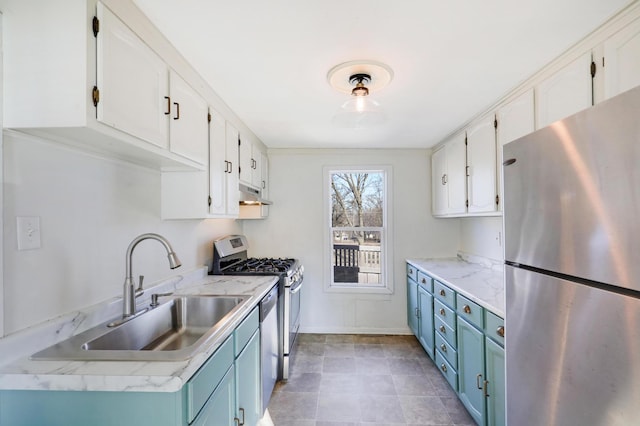 kitchen with blue cabinetry, white cabinetry, stainless steel appliances, and sink