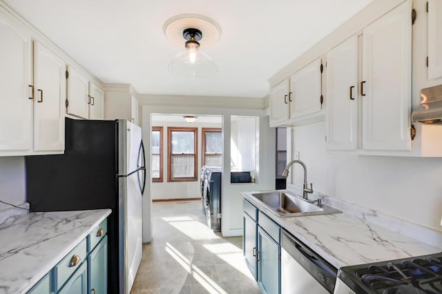 kitchen featuring stainless steel appliances, sink, white cabinets, and blue cabinetry