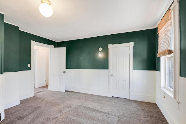 unfurnished room with light carpet