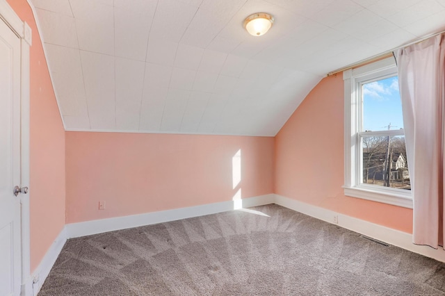 bonus room featuring lofted ceiling and carpet flooring