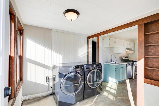 laundry room featuring cabinets, sink, and washer and dryer