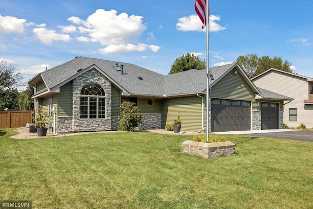 single story home featuring a garage and a front lawn