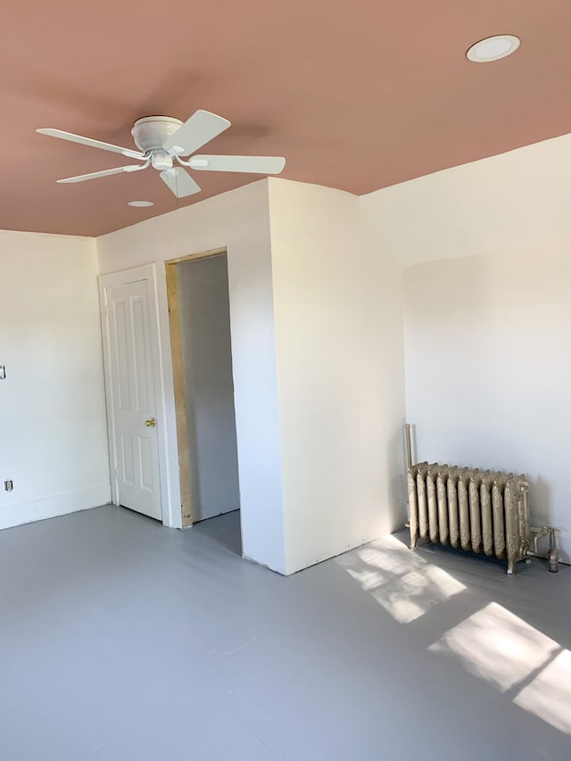 20 1st Ave NW, Plainview, MN 55964 - empty room with radiator, ceiling fan, and finished concrete floors