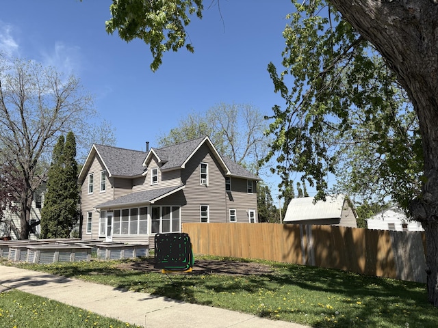 20 1st Ave NW, Plainview, MN 55964 - view of property exterior with a sunroom and a shingled roof