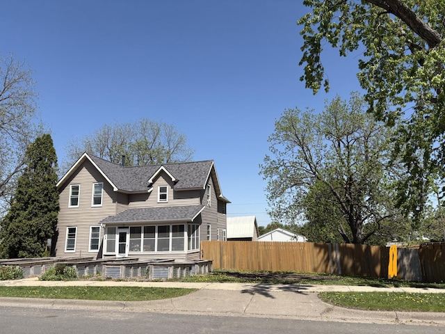 20 1st Ave NW, Plainview, MN 55964 - view of front facade featuring a sunroom, fence, and a shingled roof