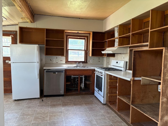 20 1st Ave NW, Plainview, MN 55964 - kitchen with open shelves, white appliances, a sink, and decorative backsplash