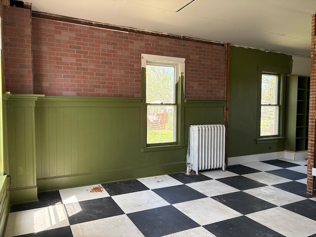 20 1st Ave NW, Plainview, MN 55964 - unfurnished room with radiator, tile patterned floors, and a wainscoted wall