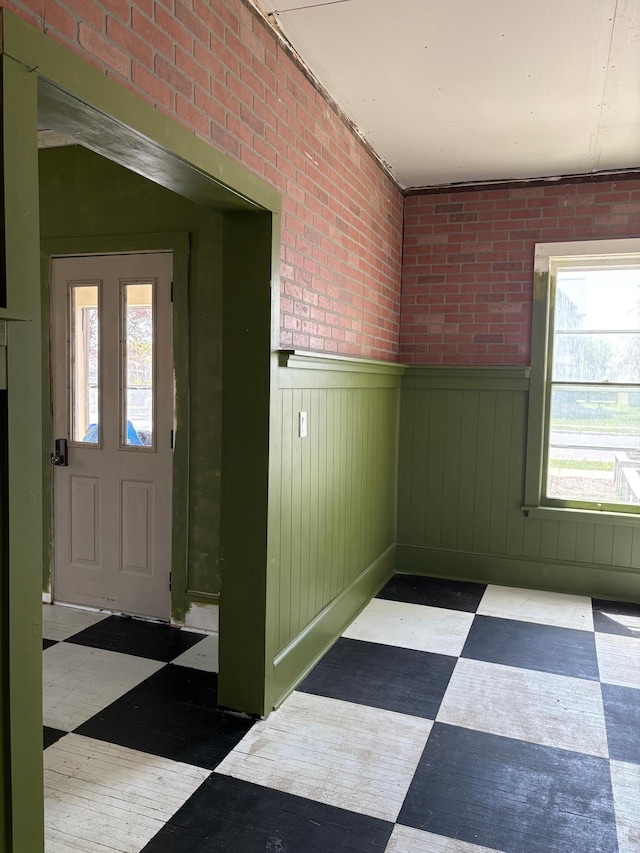 20 1st Ave NW, Plainview, MN 55964 - entryway with tile patterned floors, plenty of natural light, brick wall, and a wainscoted wall