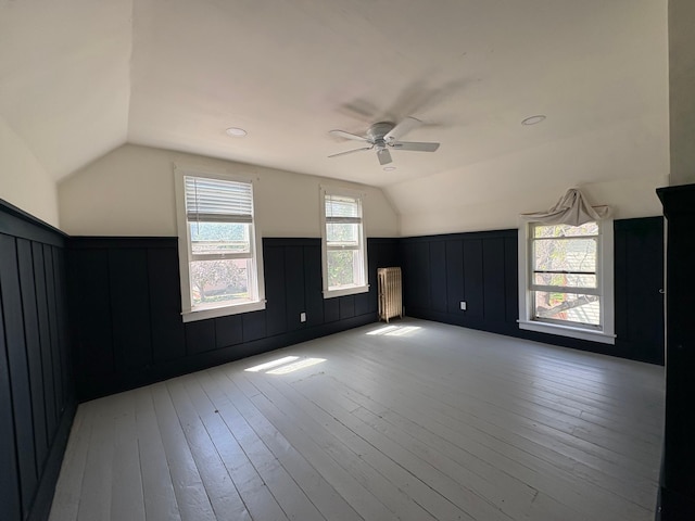 20 1st Ave NW, Plainview, MN 55964 - additional living space with lofted ceiling, ceiling fan, a wainscoted wall, light wood-type flooring, and a decorative wall