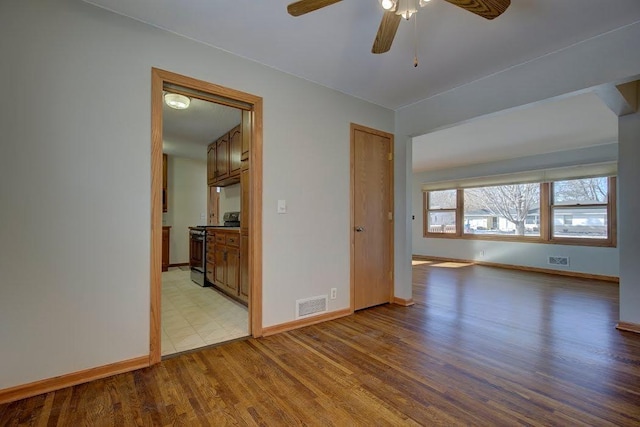 unfurnished room featuring ceiling fan and light wood-type flooring