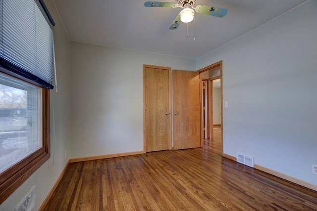 unfurnished bedroom featuring wood-type flooring, a closet, and ceiling fan