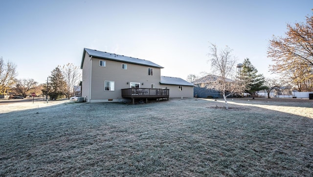 back of house featuring a wooden deck, central AC, and a lawn