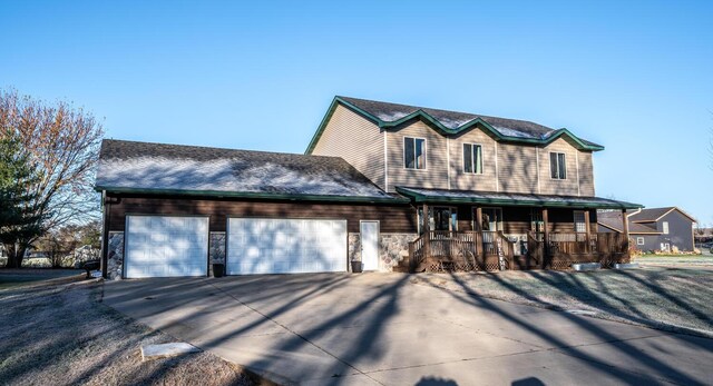 view of front of property featuring a porch and a garage