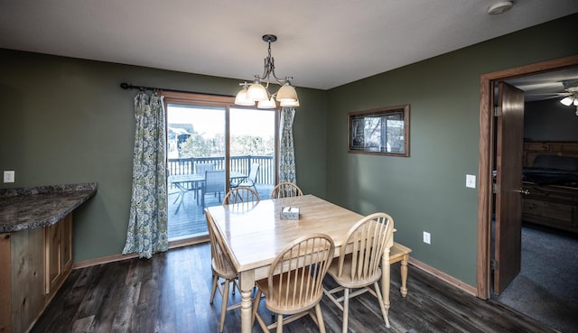 dining area with dark wood-type flooring and ceiling fan with notable chandelier