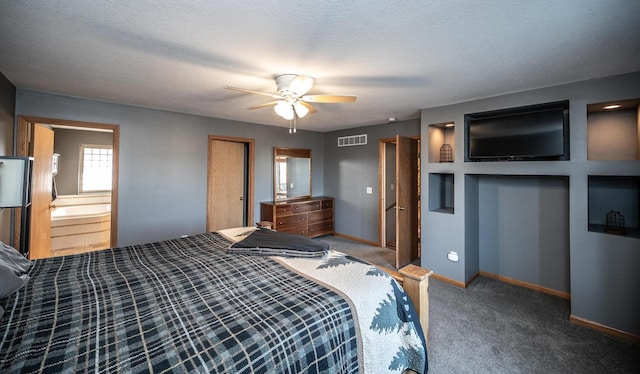 unfurnished bedroom featuring ceiling fan, carpet flooring, a textured ceiling, and ensuite bath