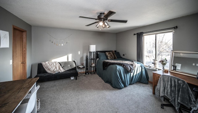 carpeted bedroom with ceiling fan and a textured ceiling