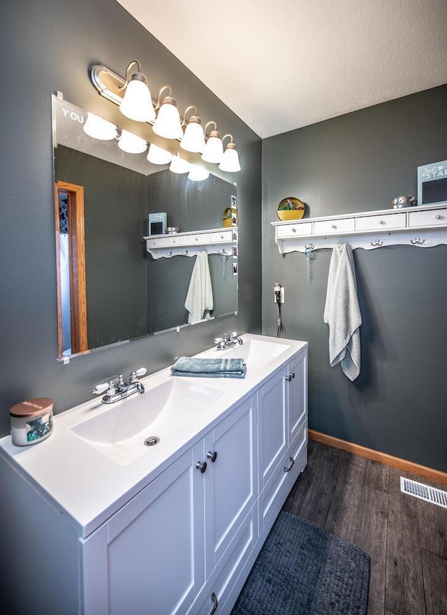 bathroom featuring vanity and hardwood / wood-style floors