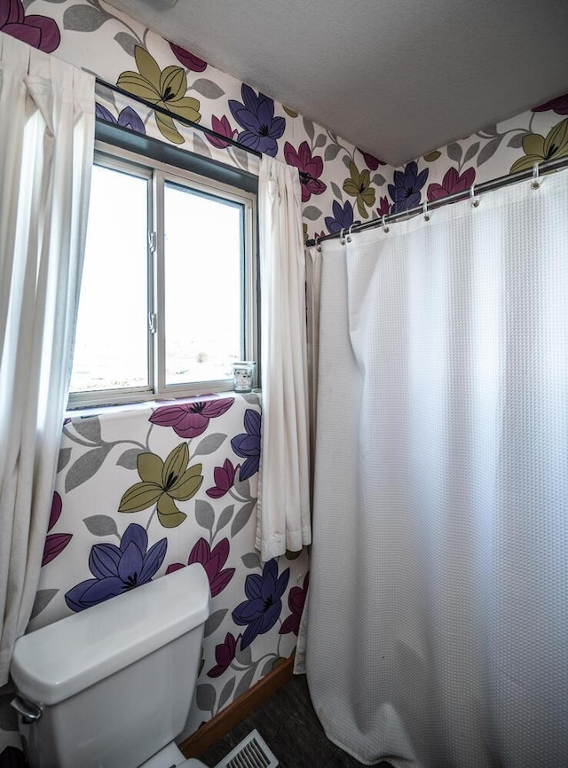 bathroom featuring a textured ceiling and toilet