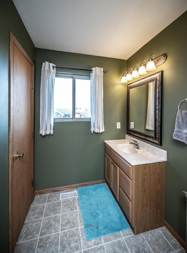 bathroom featuring tile patterned flooring and vanity